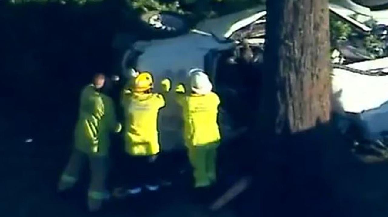 Emergency services on the scene of the crash that has claimed the life of a young mother and her son. Source: 9News.