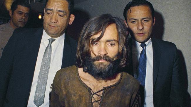 Charles Manson is escorted to his arraignment on conspiracy-murder charges in connection with the Sharon Tate murder case in 1969. Picture: AP