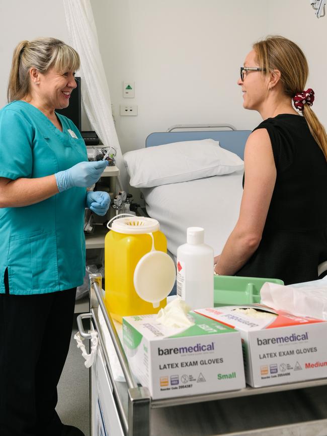 Clinical Research Nurse Mary Walker prepares to administer the vaccine to lab manager Georgina Eden. Picture: AAP Image/ Morgan Sette