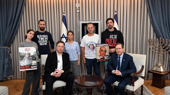 Elon Musk, left, meets with Israeli President Isaac Herzog in Jerusalem. They were joined ny familes of hostages taken by Hamas. Picture: Getty Images