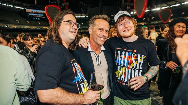 After Ed Sheeran's record-breaking performance to 109,500 people at the MCG on March 4, 2023, Mushroom Group CEO Matt Gudinski (left), singer-songwriter Mark Seymour (centre) and Sheeran (right) shared a drink together on the MCG turf. Picture: Brian Purnell / Mushroom Creative House