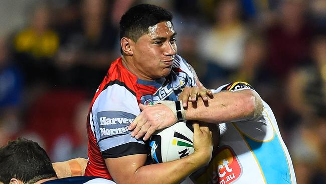 TOWNSVILLE, AUSTRALIA - AUGUST 02: Jason Taumalolo of the Cowboys is tackled by Luke Bailey and Greg Bird of the Titans during the round 21 NRL match between the North Queensland Cowboys and the Gold Coast Titans at 1300SMILES Stadium on August 2, 2014 in Townsville, Australia. (Photo by Ian Hitchcock/Getty Images)