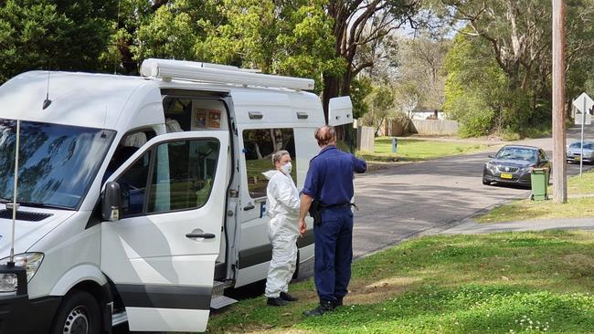 Forensic investigators arrive at a home in Narara which is the subject of a search warrant. Picture: Fiona Killman