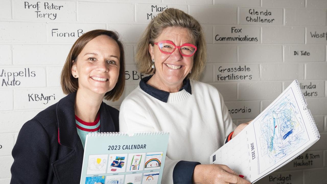 The Lighthouse Toowoomba captain Emily MacManus (left) and lighthouse keeper Emma Mactaggart with Hello Baby! 2023 calendar. Picture: Kevin Farmer