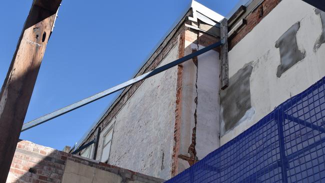 Large cracks can be seen in the wall of the former Chemist Warehouse building.