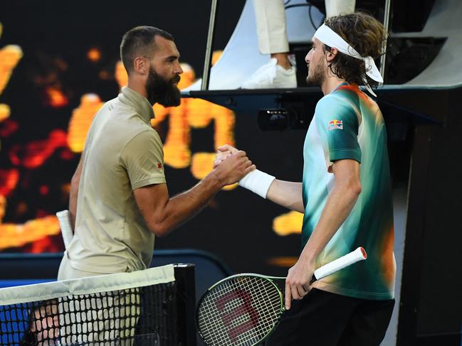 France's Benoit Paire (L) greets Greece's Stefanos Tsitsipas after their men's singles match on day six of the Australian Open tennis tournament in Melbourne on January 22, 2022. (Photo by William WEST / AFP) / -- IMAGE RESTRICTED TO EDITORIAL USE - STRICTLY NO COMMERCIAL USE --