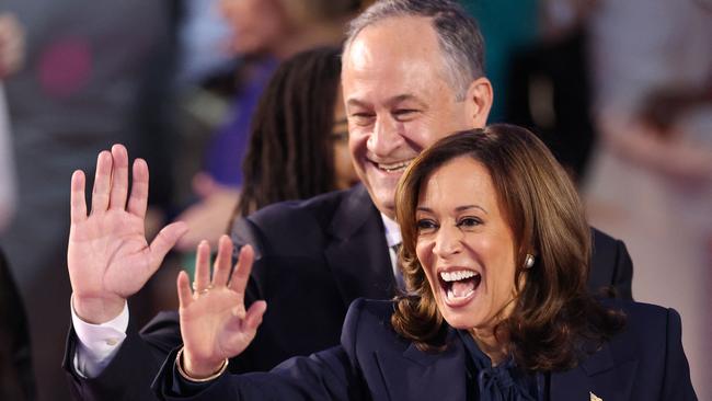 US Vice-President and 2024 Democratic presidential candidate Kamala Harris and her husband US second gentleman Douglas Emhoff wave from the stage at the Democratic National Convention on August 22. Picture: AFP