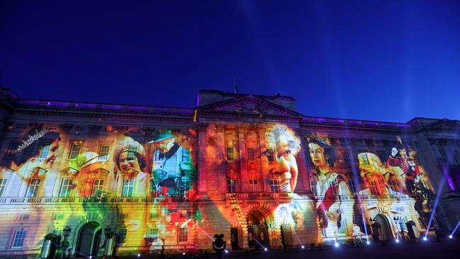 Projections are displayed on the front of Buckingham Palace depicting Queen Elizabeth II during The Lighting Of The Principal Beacon. Picture: AFP