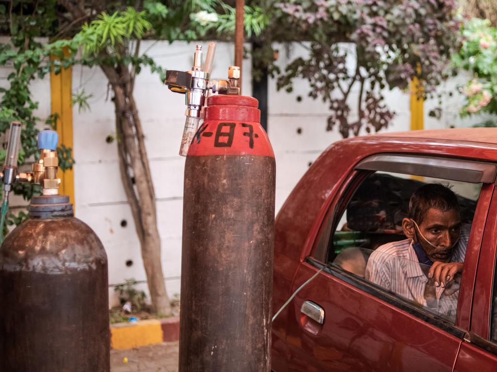 A patient suffering from COVID-19 is treated with free oxygen at a makeshift clinic in New Delhi, India. Picture: Getty Image