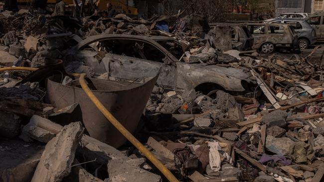 Burned cars are seen on the site of the destroyed residential building following a Russian attack in Uman, Ukraine, on Friday. Picture: Getty Images