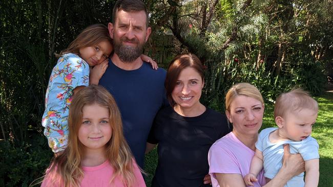 Jason and Nataliya Marrable with children Sofia (10) and Lucia (16), and Nataliya's sister Irnya and son Maxim (9 months) at their home in Bundall on the Gold Coast. Picture: Keith Woods