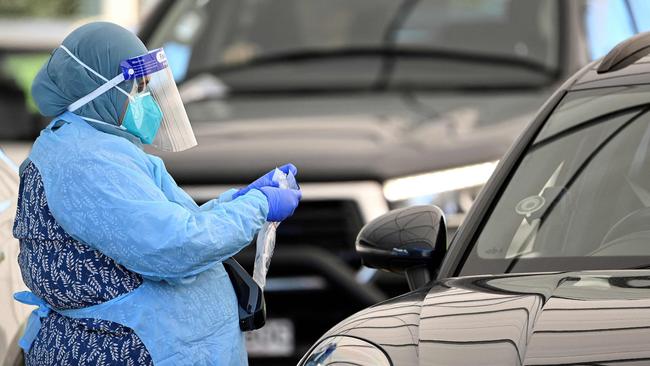 A health worker registers a resident at a COVID-19 drive through testing site on Bondi Beach. (Photo by Saeed KHAN / AFP)