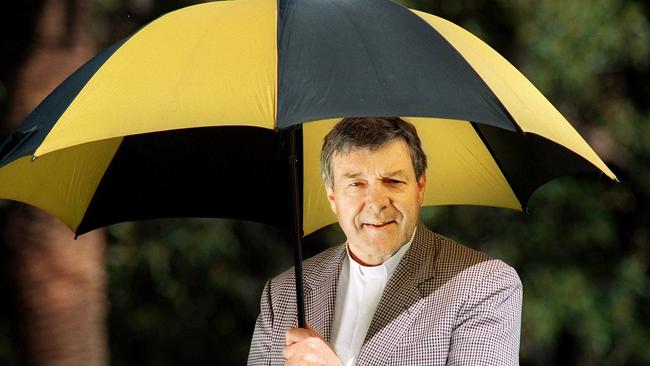 Cardinal George Pell in a 1999 photograph sporting an umbrella in Richmond colours. Picture: Rob Leeson