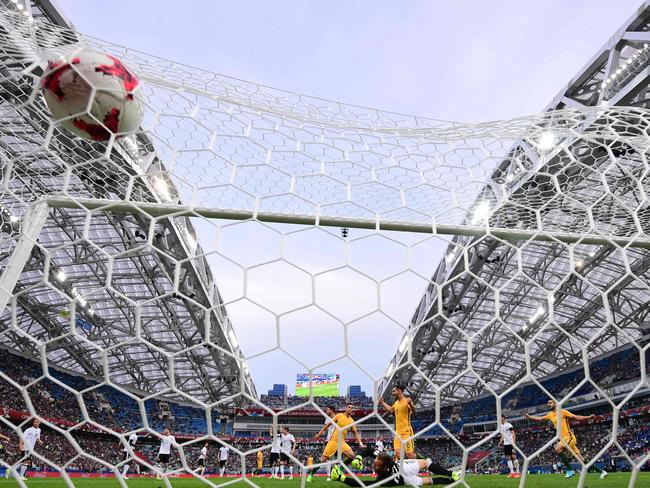 Australia's forward Tomi Juric scores a goal past Germany's goalkeeper Bernd Leno.