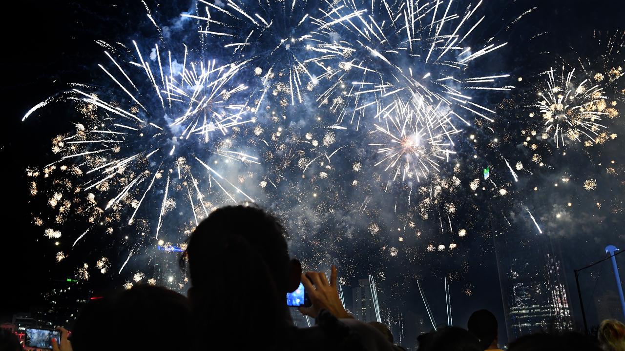 Crowds watch a fireworks display during New Year's Eve celebrations in Brisbane. (AAP Image/Dan Peled)