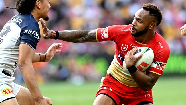 BRISBANE, AUSTRALIA - MARCH 10: Hamiso Tabuai-Fidow of the Dolphins pushes away the defence during the round one NRL match between the Dolphins and North Queensland Cowboys at Suncorp Stadium, on March 10, 2024, in Brisbane, Australia. (Photo by Bradley Kanaris/Getty Images)