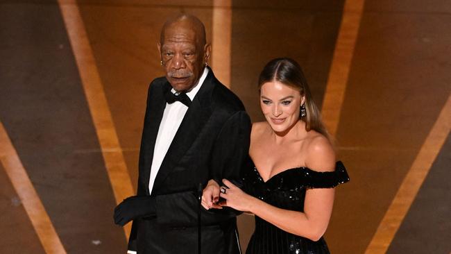 Morgan Freeman wore a black glove on his left hand as he presented the Oscars (Photo by Patrick T. Fallon / AFP)