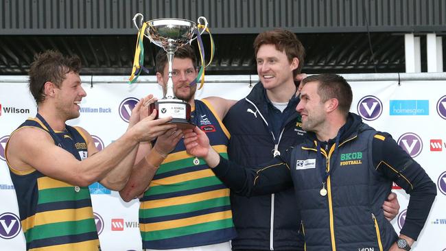 (From left) Captains Nick Wood and Anthony Lynch and coaches Tom Williams and Guy Martyn raise the silverware  Picture: Hamish Blair