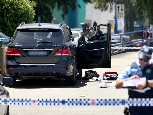 Police at the crime scene where Mick Hawi’s Mercedes sits in the gym car park at Rockdale on Thursday. Picture: Toby Zerna