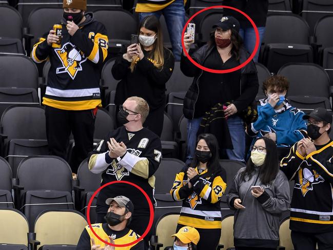 In the original image, masks aren't completely covering the faces of two fans.