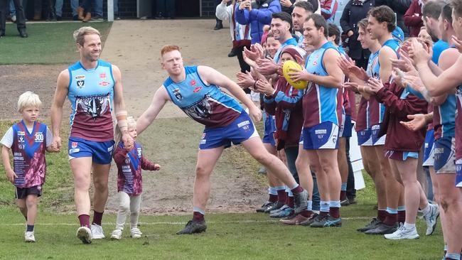 Josh Finch walks onto the field for his 300th game with his kids Lenny, 7, and Myla, 4. Picture: Mark Wilson