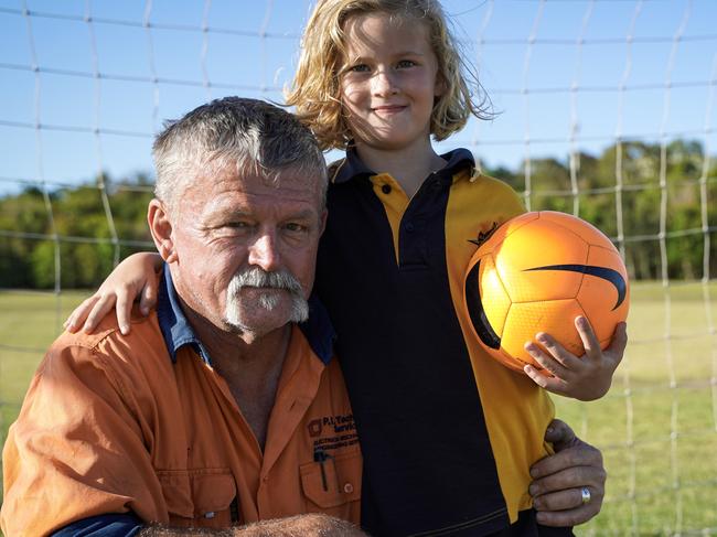 Mackay dad Scott Mealey with youngest daughter, Niamh, 7. Niamh has four older siblings, each who enrolled into junior soccer and earning. Picture: Heidi Petith