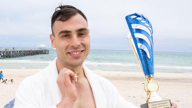 George Langanis, 29, from Lightsview, who caught the cross at the blessing of the waters by the Greek Orthodox Church at Henley Beach, Henley on Sunday, January 7, 2023. (The Advertiser/ Morgan Sette)