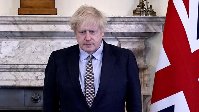 Boris Johnson observes silence in Downing Street to mark the 75th anniversary of Victory in Europe Day on Friday. Picture: Pool/AFP