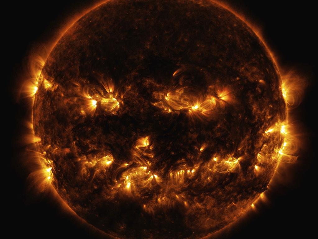 In this Oct. 8, 2014 photo released by NASA, active regions on the sun combine to look something like a jack-o-lanternâ€™s face. The image was captured by NASA's Solar Dynamics Observatory, or SDO, which watches the sun at all times from its orbit in space. (NASA via AP)