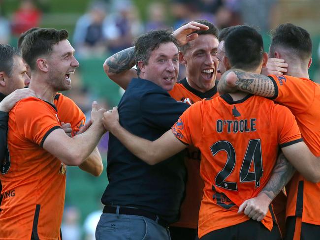 PERTH, AUSTRALIA - OCTOBER 13: Robbie Fowler coach of the Roar celebrates with his players after a gaol by Roy O