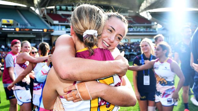 Lions Tahlia Hickie and Greta Bodey embrace after the final siren. Picture: Mark Brake/Getty Images)