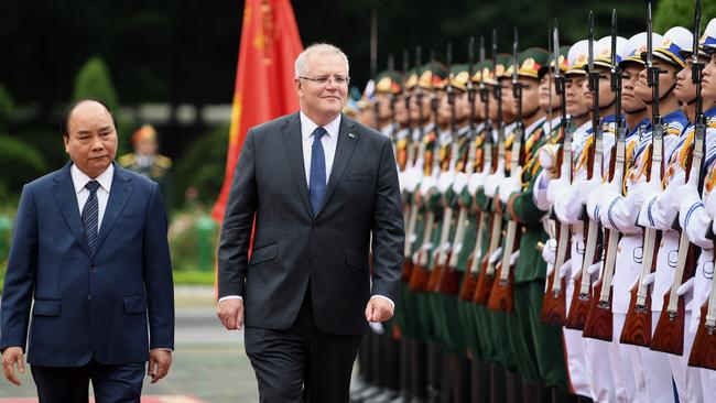 Prime Minister of the Socialist Republic of Vietnam Nguyen Xuan Phuc and Scott Morrison inspect a guard of honour at the Presidential Palace in Hanoi, Vietnam, on Friday. Picture: AAP/Lukas Coch