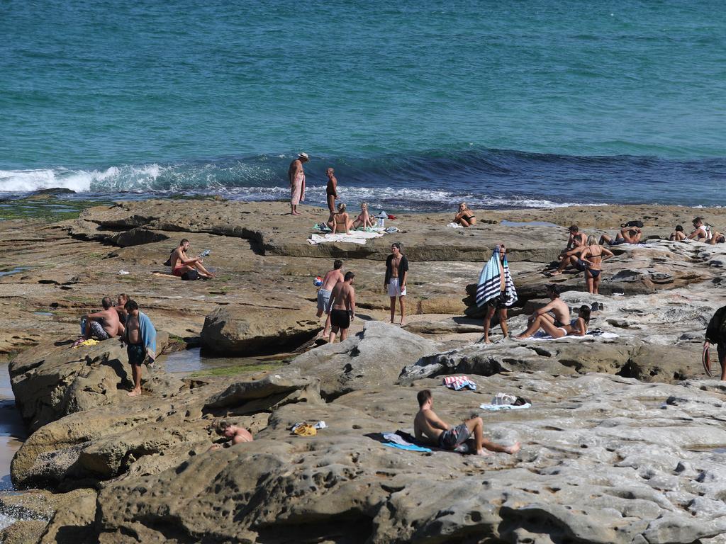 People in the Bondi area, including Mackenzie's Beach which is officially closed, have not been obeying social distancing rules despite the area becoming a hotspot for the virus. Picture: Rohan Kelly
