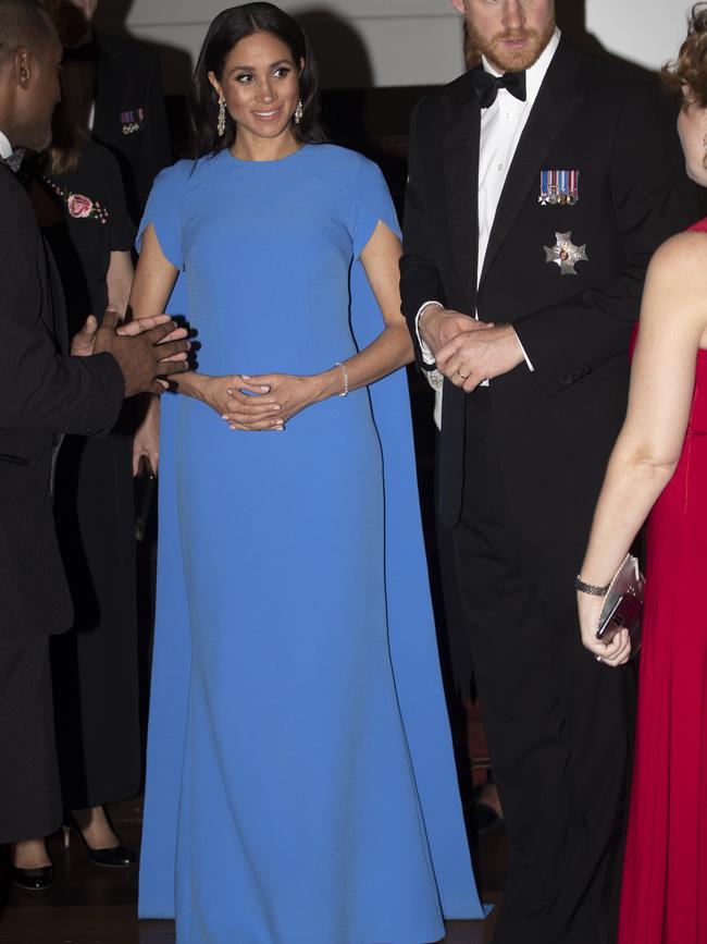 The Duchess of Sussex gave the first glimpse of her baby bump in Fiji, wearing a gorgeous blue gown. Picture: Ian Vogler — Pool/Getty Images