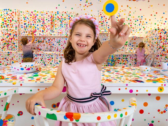 Tiffany, 6  inside the NGV's latest childrens exhibition Kusama for Kids: The Obliteration Room which invites children to put colourful stickers all over the white walls and furniture. The free exhibition is open until April 21.Picture: Jason Edwards