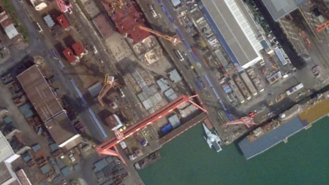 A satellite image of Guangzhou Shipyard International taken on October 23, 2024, showing, among other things, what looks to be a new class of Chinese ship with a large flight deck. PHOTO © 2024 PLANET LABS INC.