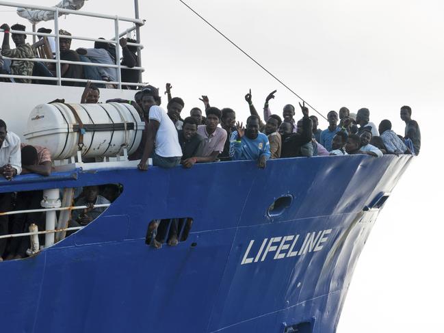 In this photo taken on Thursday, June 21, 2018, migrants wave from aboard ship operated by the German NGO Mission Lifeline. Italy's interior minister says Malta should allow a Dutch-flagged rescue ship carrying 224 migrants to make port there because the ship is now in Maltese waters. Salvini said the rescue was in Libyan waters, which Lifeline denies. (Hermine Poschmann/Mission Lifeline via AP)