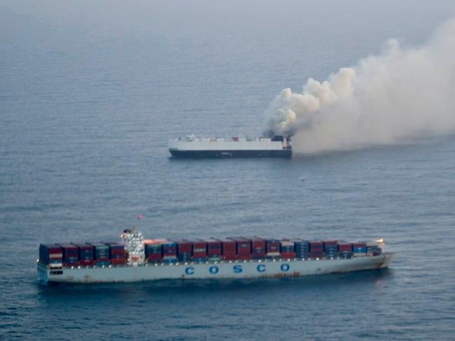 In this photo provided by the U.S. Coast Guard, smoke rises from cargo vessel Morning Midas approximately 300 miles south of Adak, Alaska, June 3, 2025, as the crew of a cargo ship carrying about 3,000 vehicles to Mexico, abandoned ship after they could not control a fire. (U.S. Coast Guard/Courtesy of Air Station Kodiak via AP)