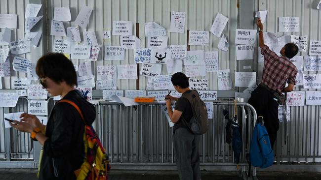 Residents of Hong Kong have begun pasting placards damning the extradition law proposal on walls near the Legislative Council. Picture: Hector Retamal/AFP