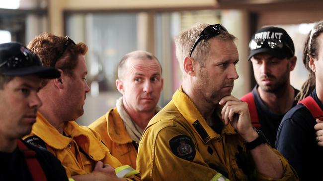 Luke Mellers (hand on chin) listens to morning briefing at Geeveston fire station. Picture: LUKE BOWDEN