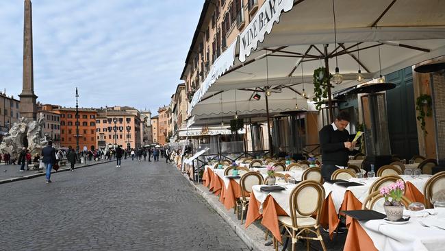 A waiter stands at a deserted restaurant at Piazza Navona in Rome on Thursday Picture: AFP