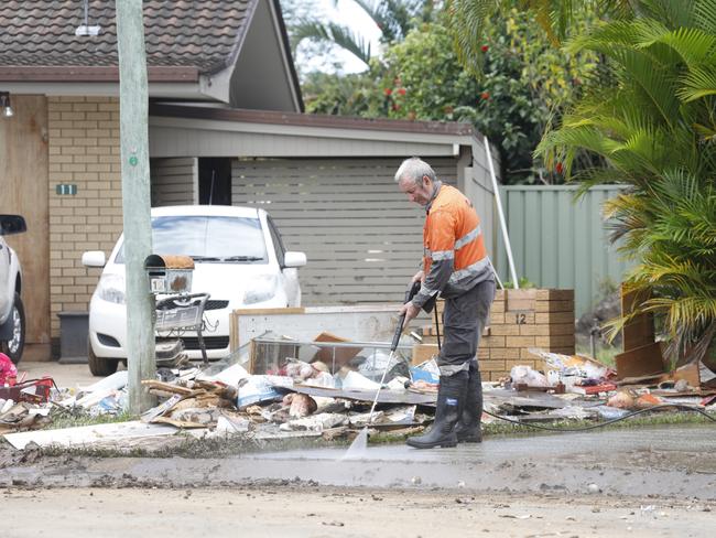 A Mullumbimby resident cleaning up. Picture: Liana Boss