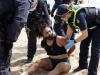 Police arrest a woman at a Melbourne beach on the weekend.
