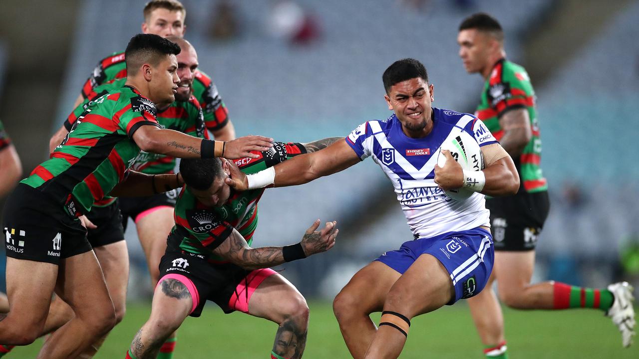 Tim Lafai of the Bulldogs fends off the Bunnies defence