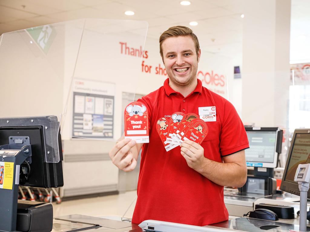 Coles worker Hayden Allen with Coles Christmas donation cards for SecondBite and Redkite.