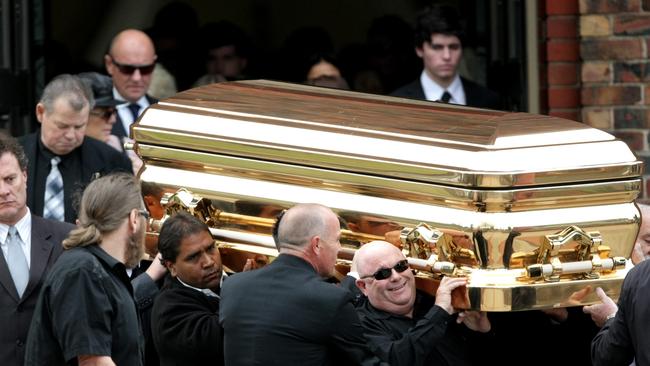 The gold coffin carrying the body of gangland killer Carl Williams leaving his funeral service at a church in Essendon in 2010.