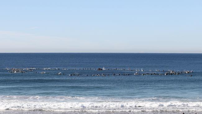 Surfers form a ring in memory of Alex 'Chumpy' Pullin at North Narrabeen Beach. Picture: Ryan Pierse/Getty Images