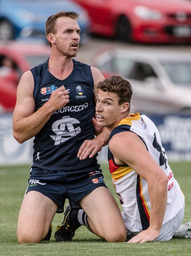 It’s Easter weekend so why shouldn’t South Adelaide defender Brad Crabb pray for a win over the Crows and Josh Jenkins. Picture: Morgan Sette/AAP