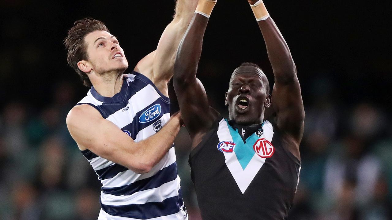 ADELAIDE, AUSTRALIA - AUGUST 27: Aliir Aliir of the Power marks the ball from Isaac Smith of the Cats during the 2021 AFL Second Qualifying Final match between the Port Adelaide Power and the Geelong Cats at Adelaide Oval on August 27, 2021 in Adelaide, Australia. (Photo by Sarah Reed/AFL Photos via Getty Images)