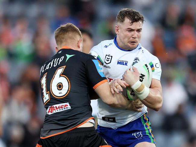 SYDNEY, AUSTRALIA - JUNE 23: Hudson Young of the Raiders is tackled during the round 16 NRL match between Wests Tigers and Canberra Raiders at Campbelltown Stadium, on June 23, 2024, in Sydney, Australia. (Photo by Matt King/Getty Images)